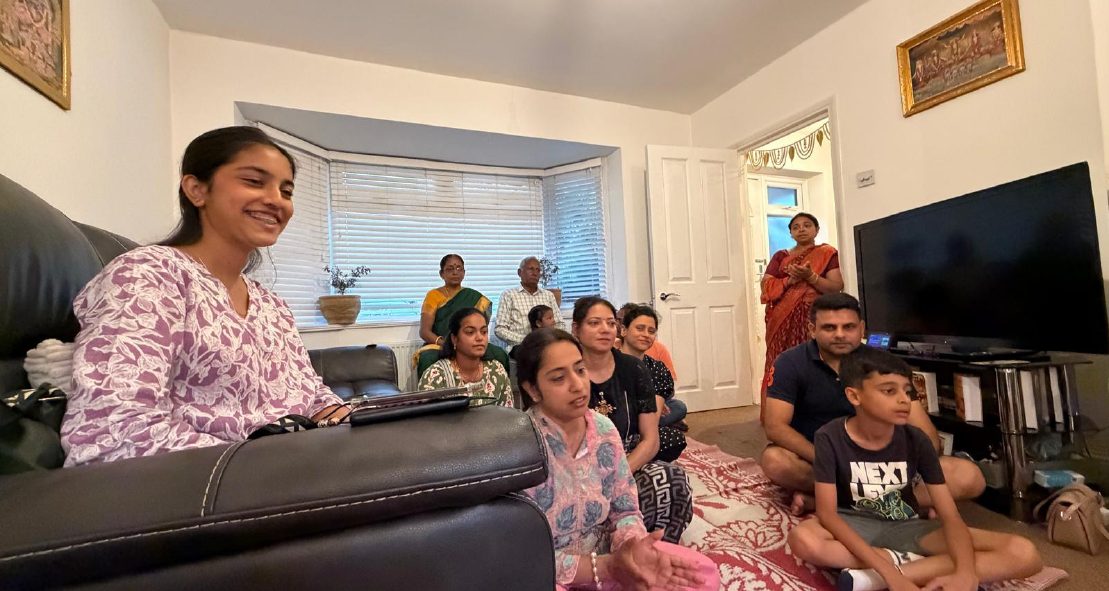 Community kirtana gathering in a home setting