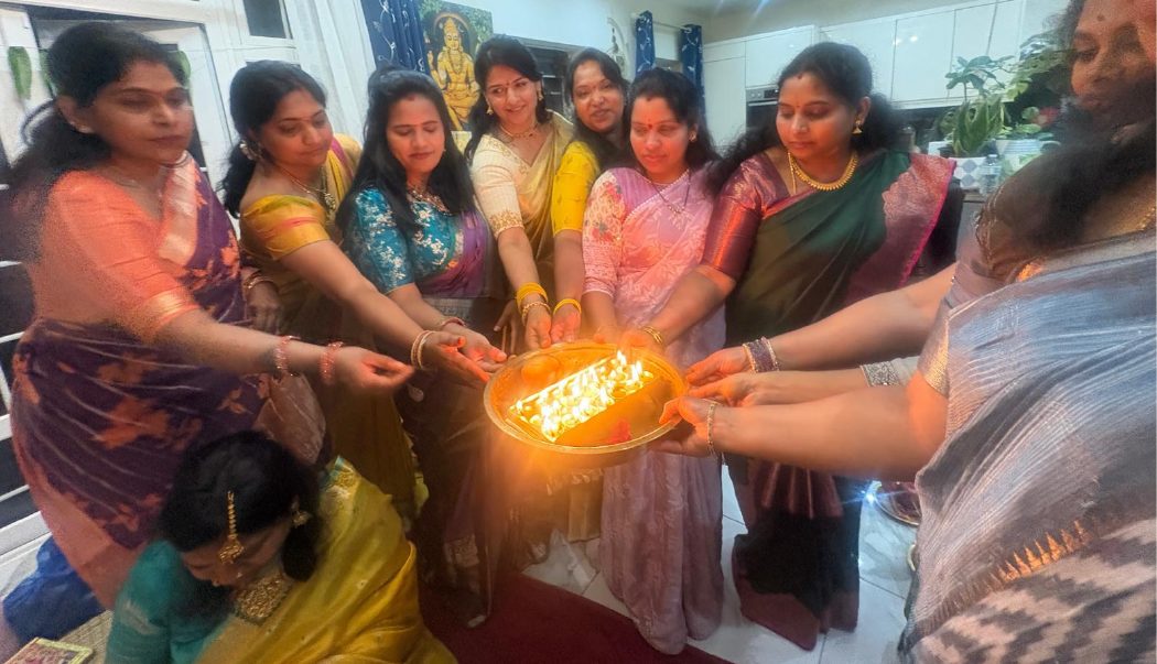 Devotees performing an arati offering during Purushottama Month