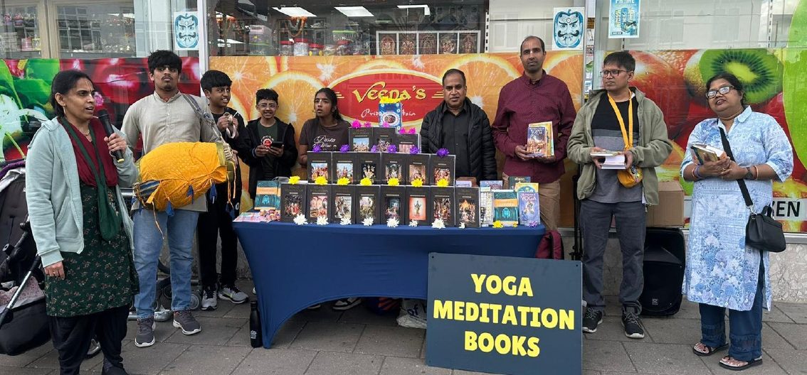 Book distribution stall with yoga and meditation books signage