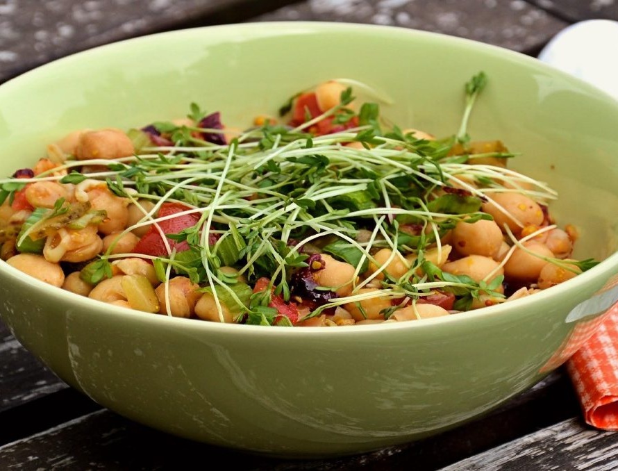 Bowl of cooling sattvik chana chaat salad garnished with sprouts