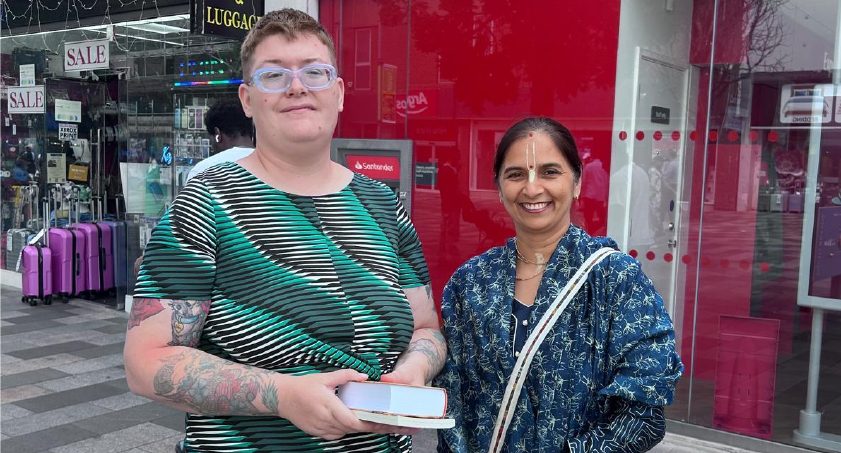 Manoraksi Mataji distributing books on a high street